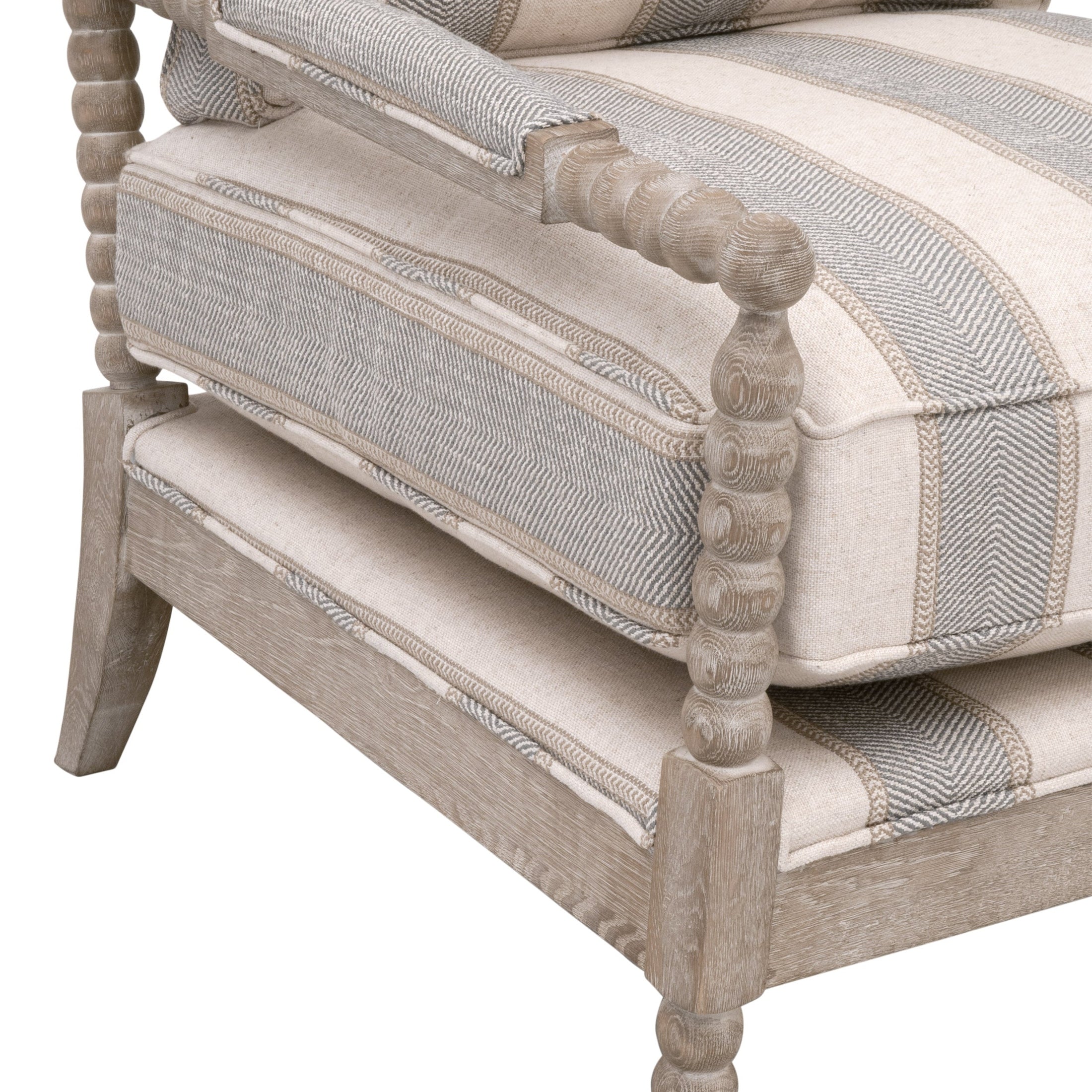 Close-up of Rouleau Club Chair’s natural gray oak frame with hand-carved spool detailing and striped upholstery cushions