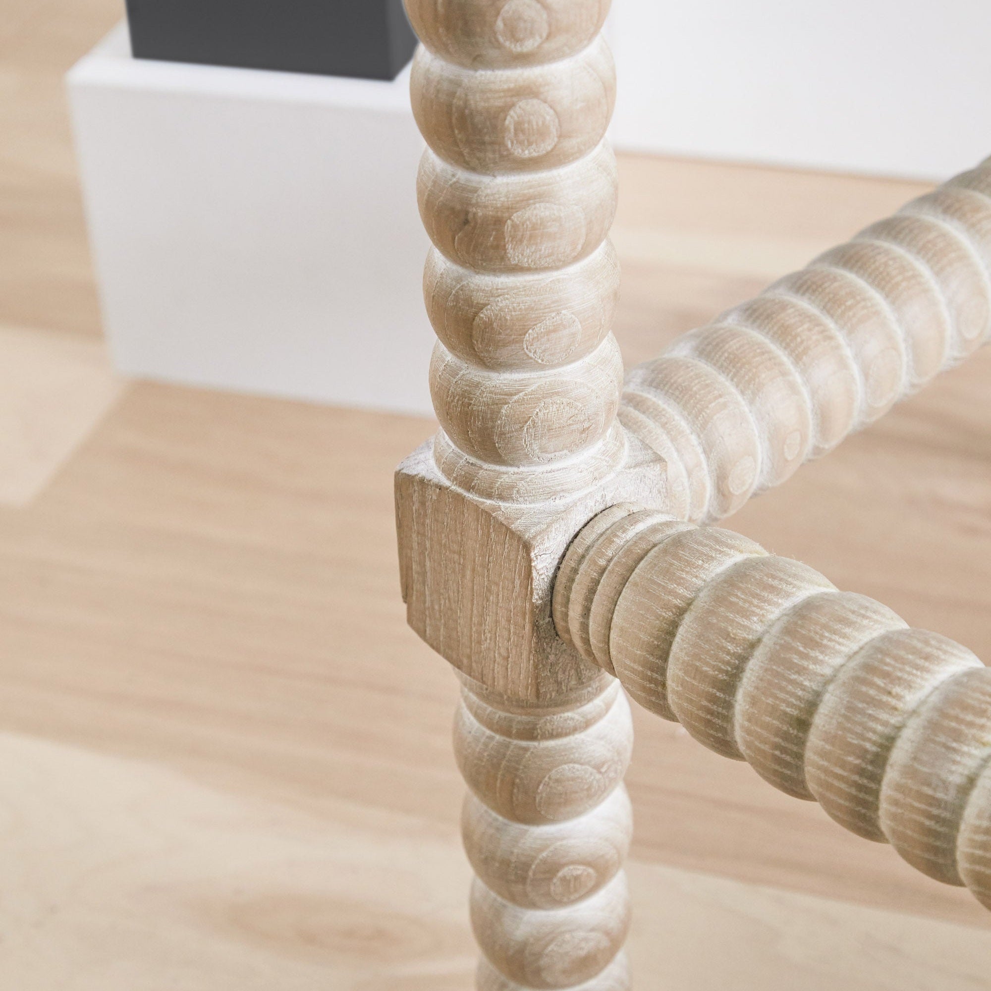 Close-up of natural gray ash bobbin-turned legs and scalloped apron detail on Rue Counter Stool by Essentials for Living