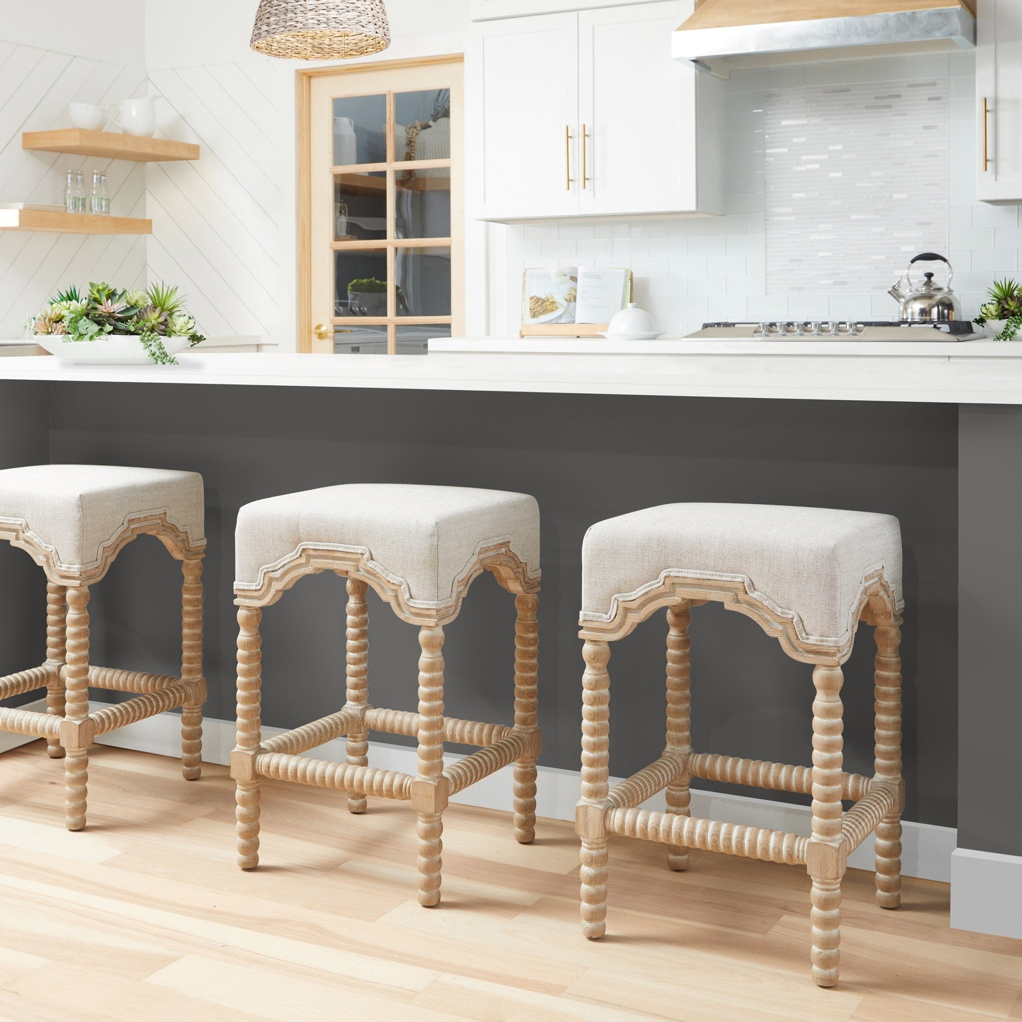 Rue Counter Stools with bisque linen seats and natural gray ash bobbin-turned legs by Essentials For Living in a modern kitchen setting