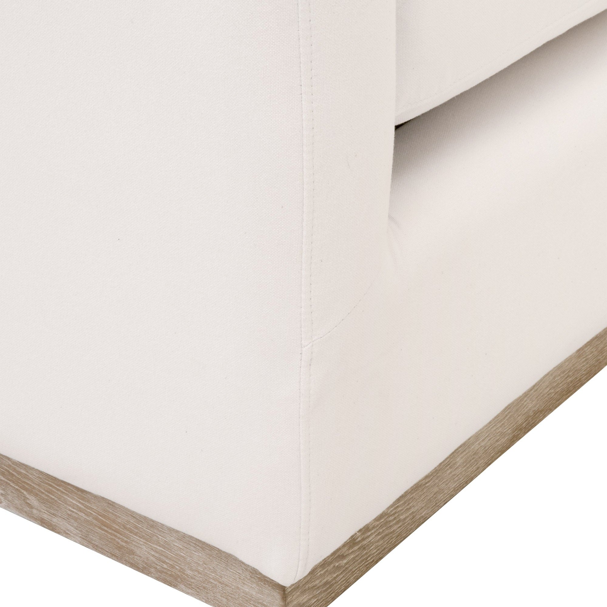 Close-up of Siena Plinth Base Sofa Chair corner with ivory upholstery and natural gray oak base by Essentials For Living