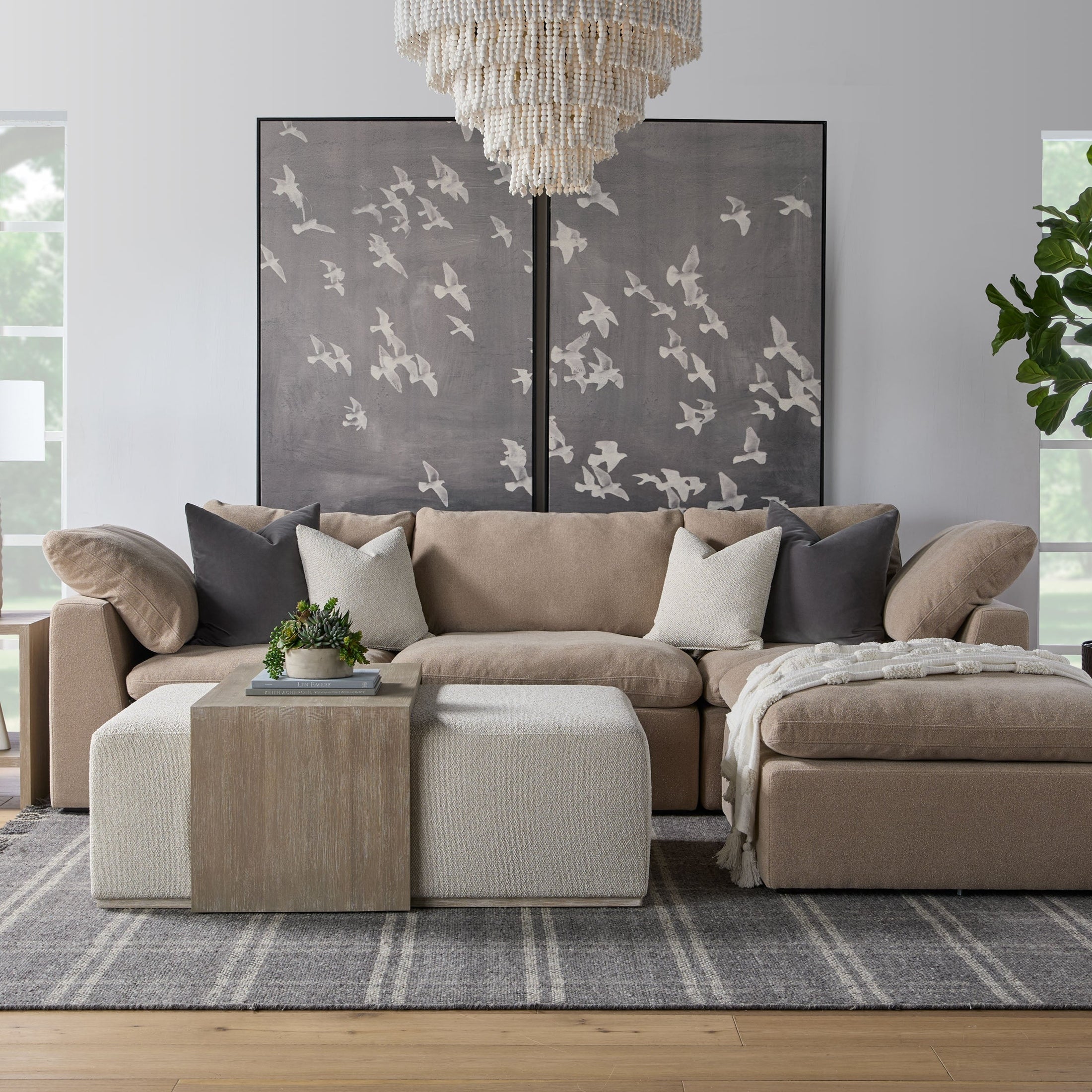 Cozy neutral modular sofa with plush cushions and decorative pillows in a bright living room setting
