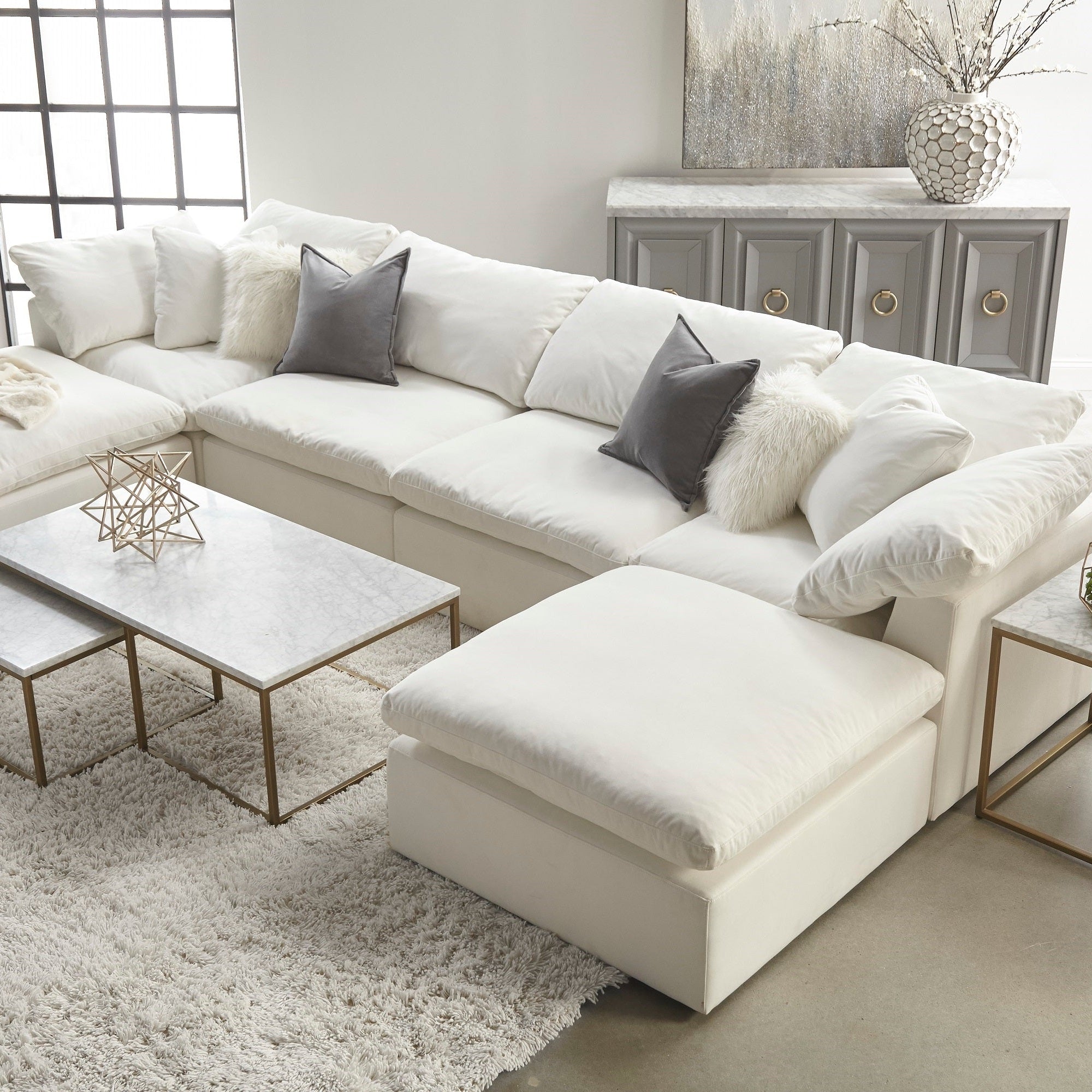 White modular ottoman with plush cushions in a stylish living room setting by Essentials For Living