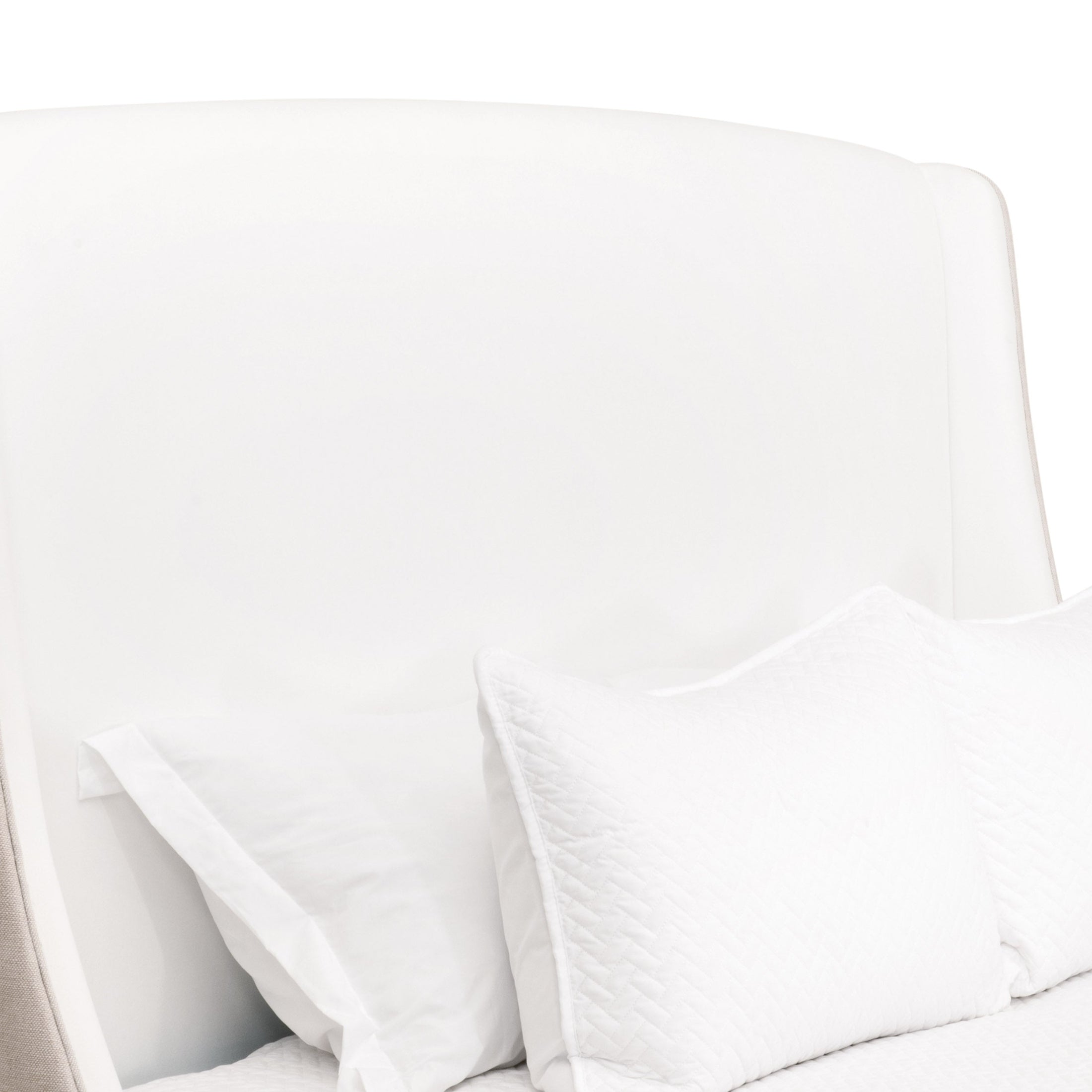 Close-up of Sloan Standard King Bed upholstered headboard in crisp white with textured pillows by Essentials for Living