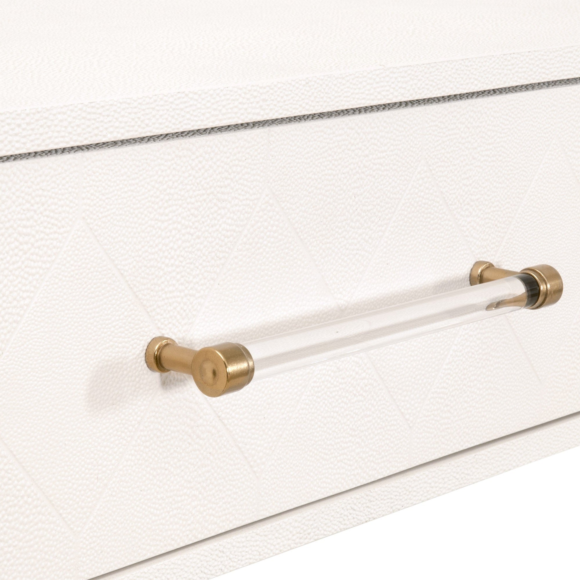 Close-up of pearl faux shagreen drawer with clear acrylic handle and brushed brass accents on console table drawer front