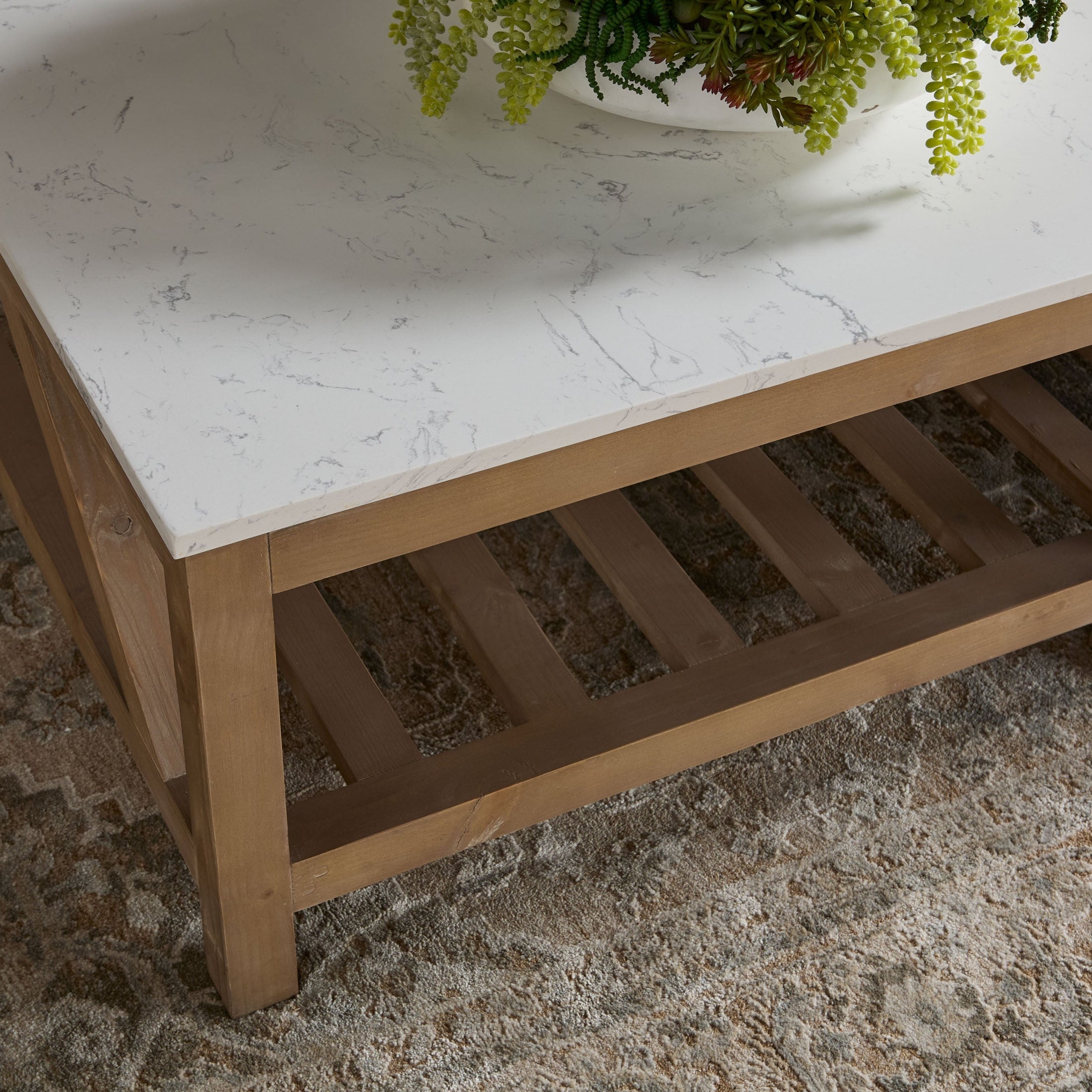 Essentials For Living Spruce Coffee Table with white quartz top and smoke gray reclaimed pine wood base on patterned rug