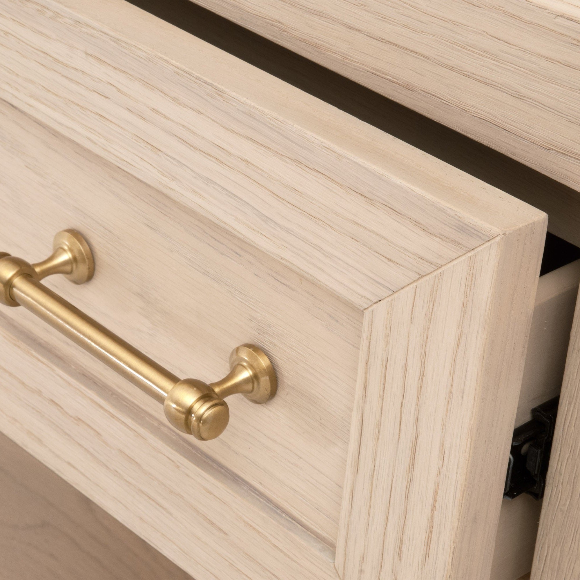 Close-up of Essentials For Living Stella nightstand drawer with brushed brass handle and white wood finish