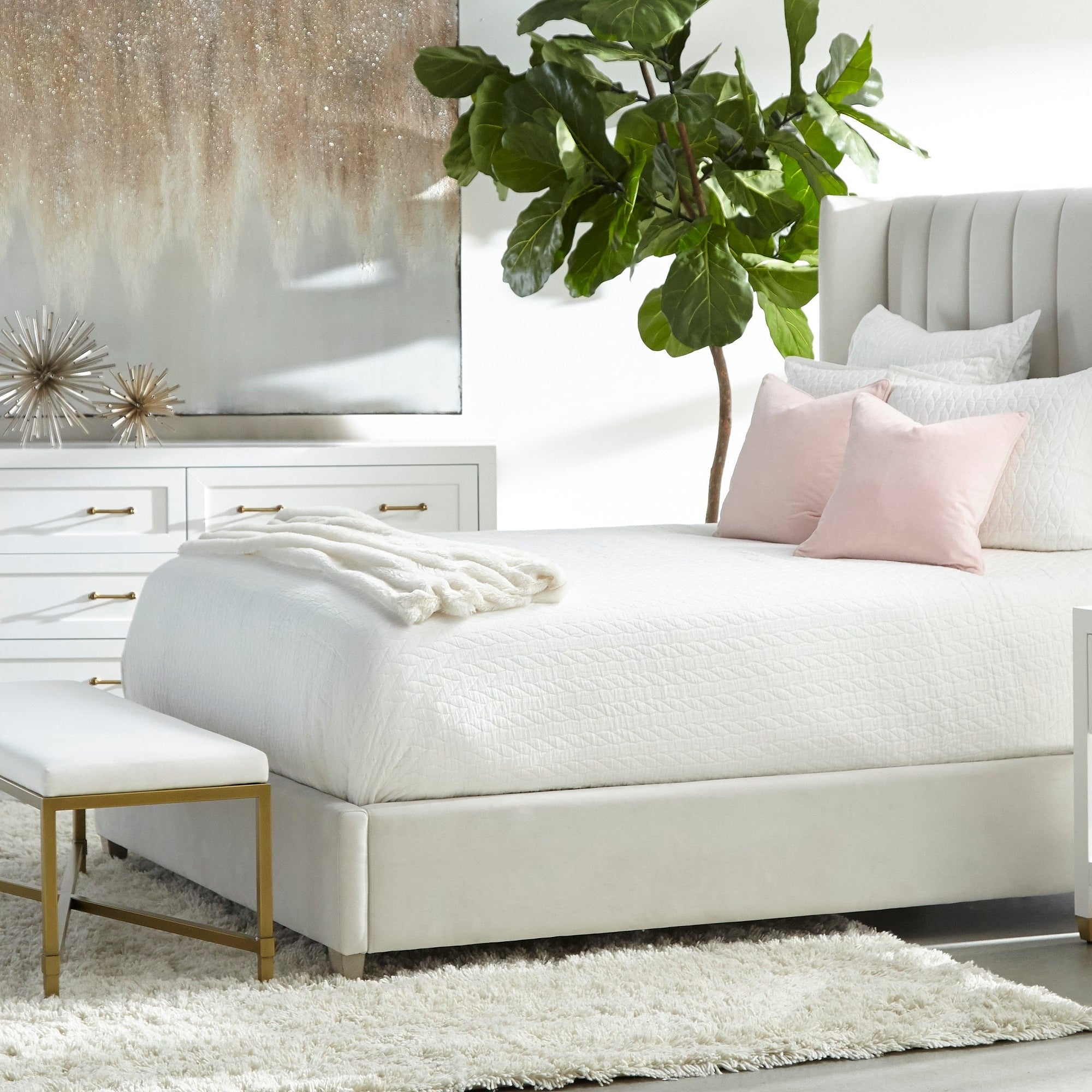 Essentials For Living Stella dresser in matte white lacquer with brushed brass handles in a modern bedroom setting