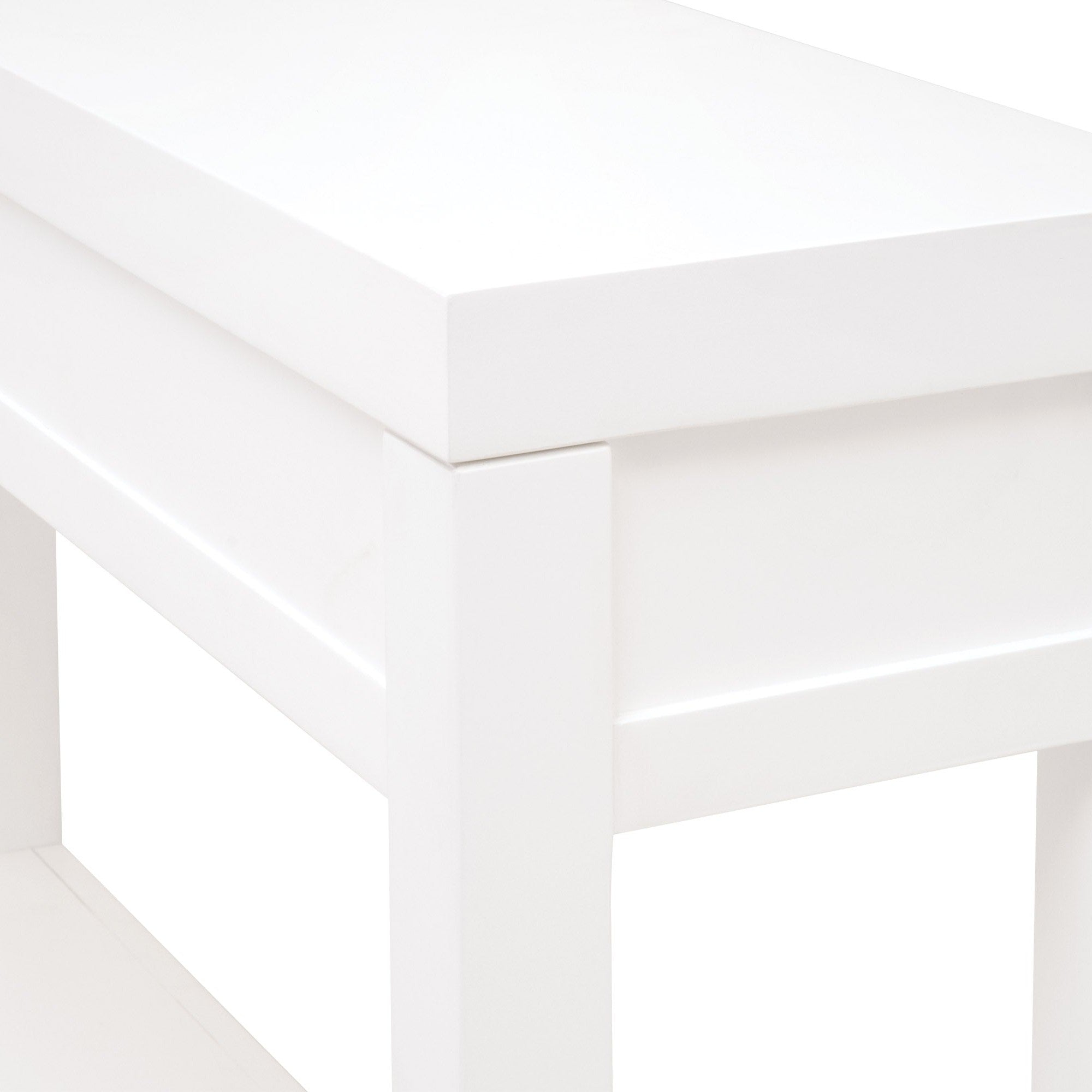 Close-up of white narrow console table corner highlighting clean modern lines and smooth finish