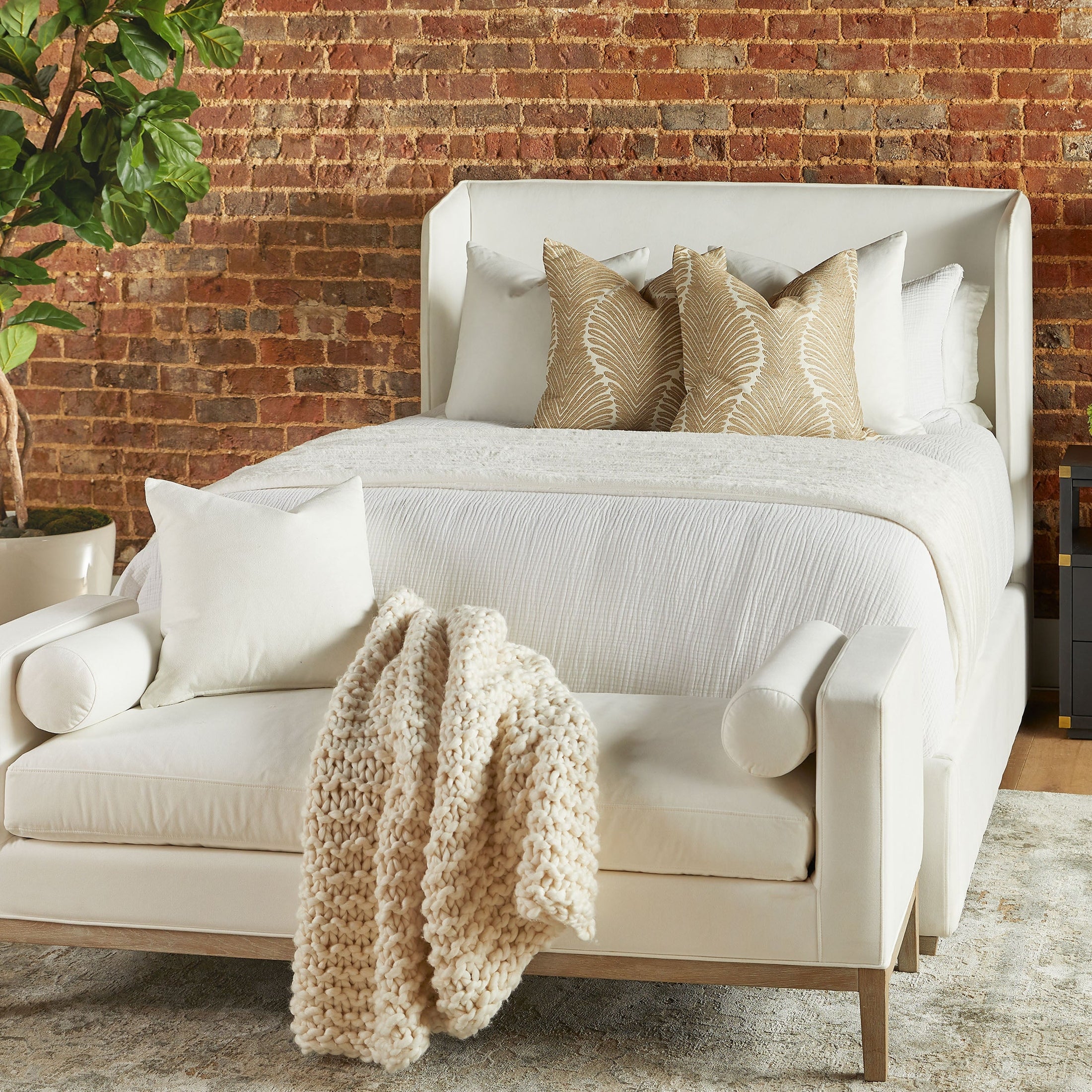 Stewart Queen Bed by Essentials for Living with upholstered slanted wingback headboard and natural gray oak feet in cozy bedroom setting
