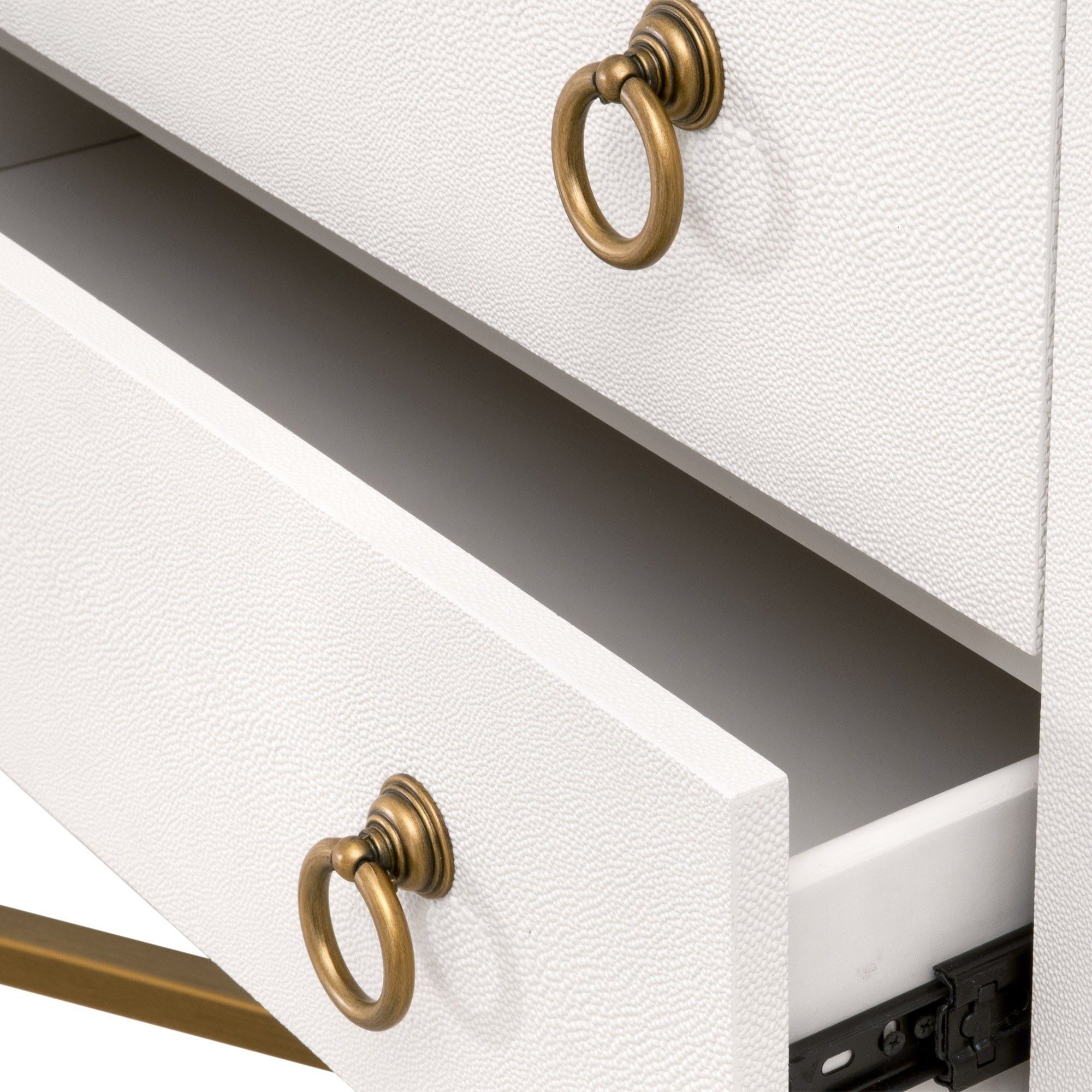 Close-up of a white Strand Shagreen 2-drawer nightstand with gold ring pulls and textured finish by Essentials for Living