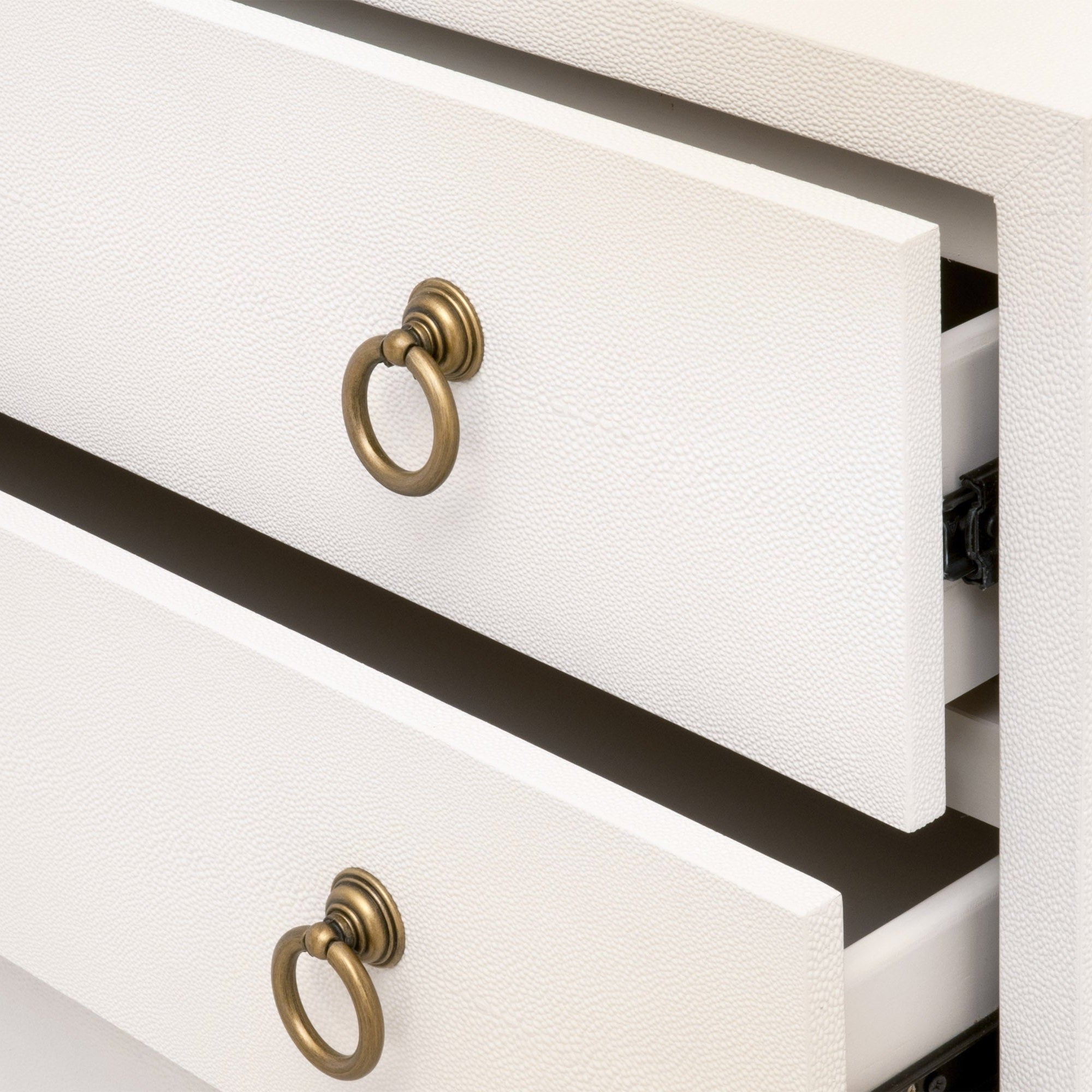 Close-up of pearl white faux shagreen nightstand drawers with brushed gold ring pulls by Essentials For Living