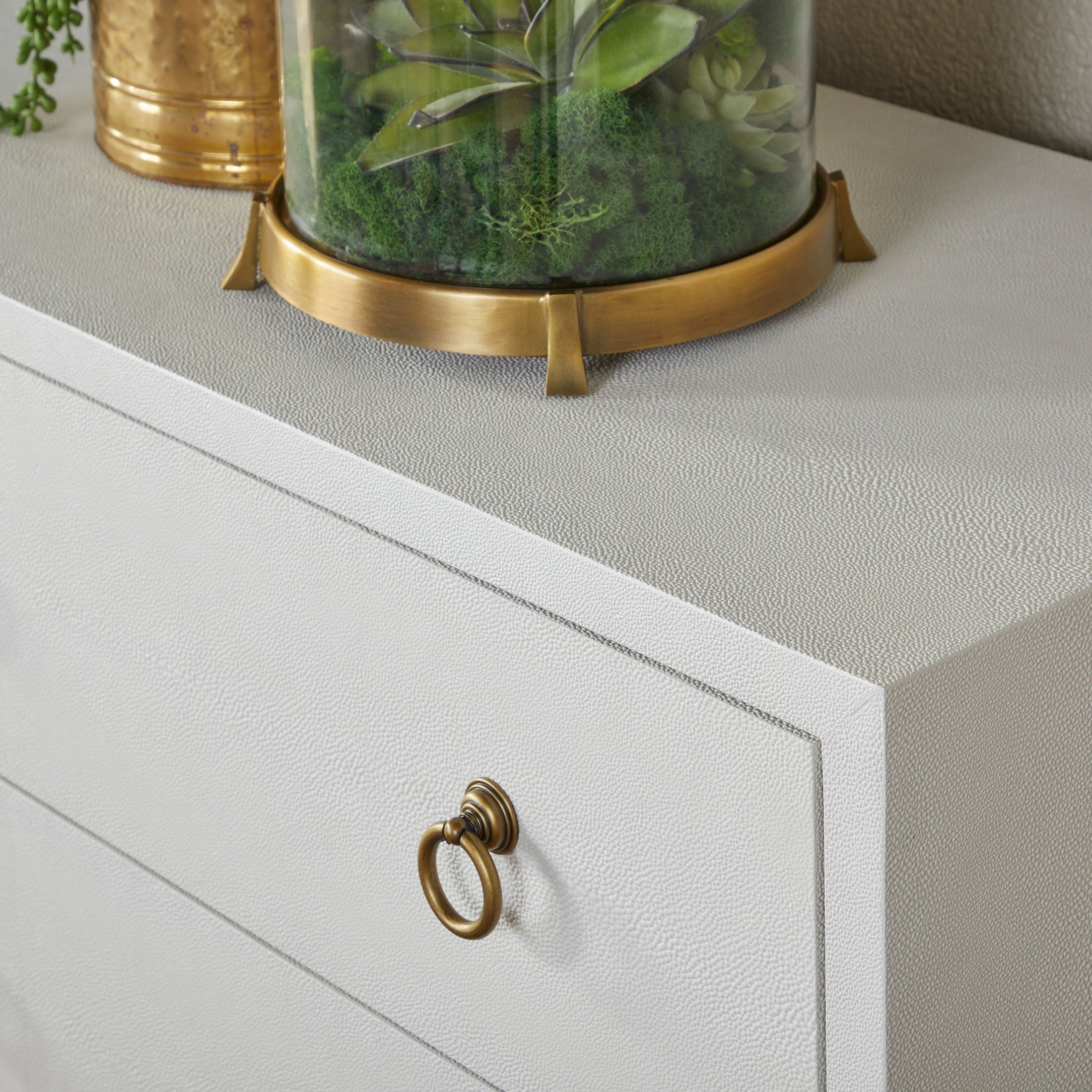 Close-up of pearl white faux shagreen texture and brushed gold ring pull on Essentials for Living Strand double dresser drawer