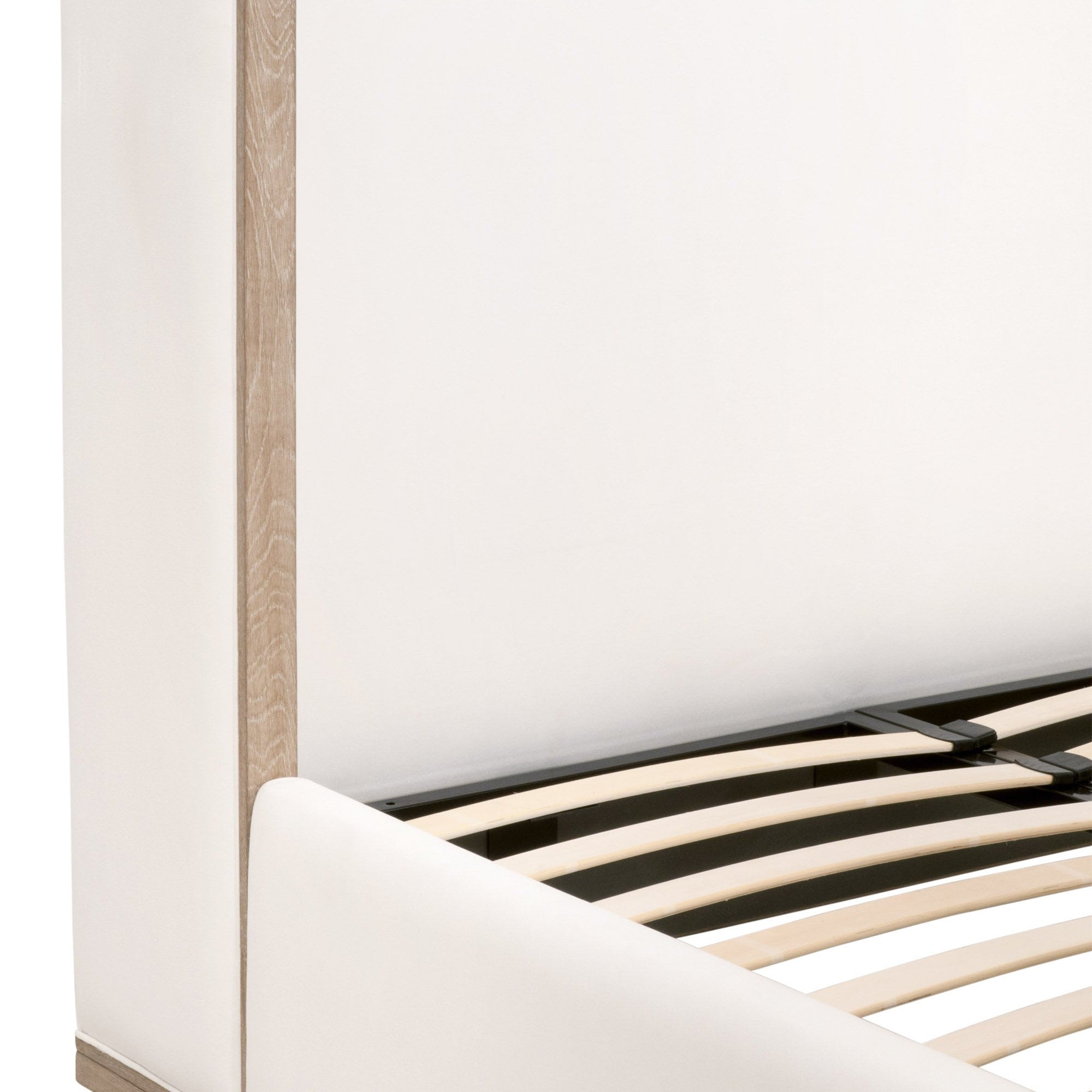 Close-up of Essentials For Living Tailor Shelter Queen Bed’s upholstered frame with natural gray oak accents and slatted base