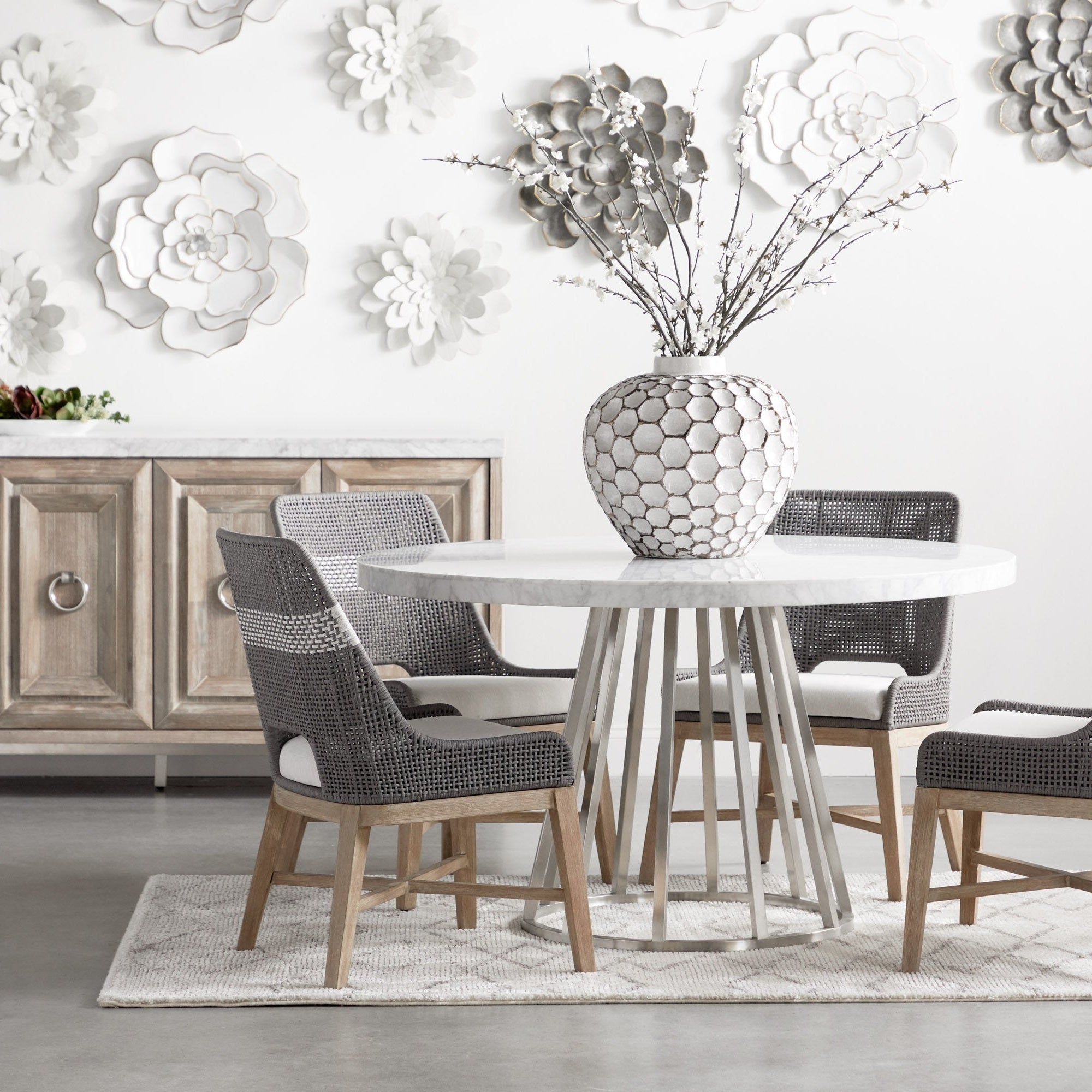 Set of two Essentials for Living tapestry dining chairs with woven taupe seats and solid mahogany legs beside round table