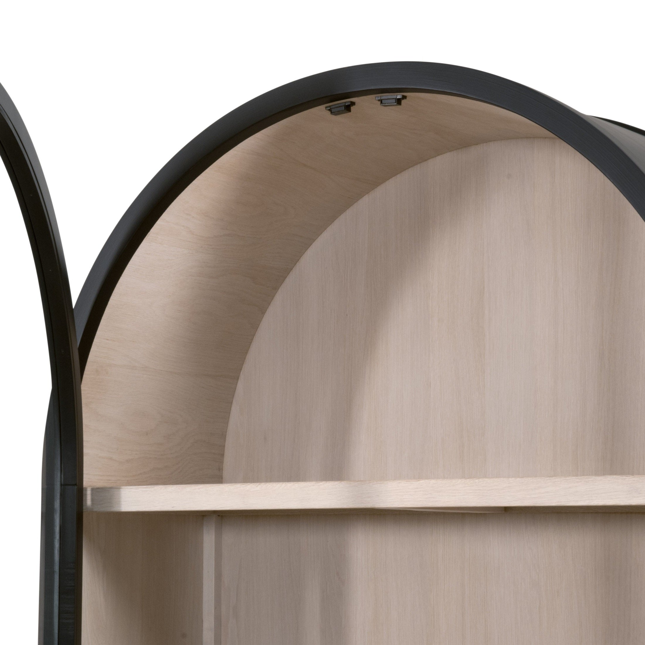 Close-up of black birch arched display cabinet interior with light oak shelf and smooth wood grain finish.