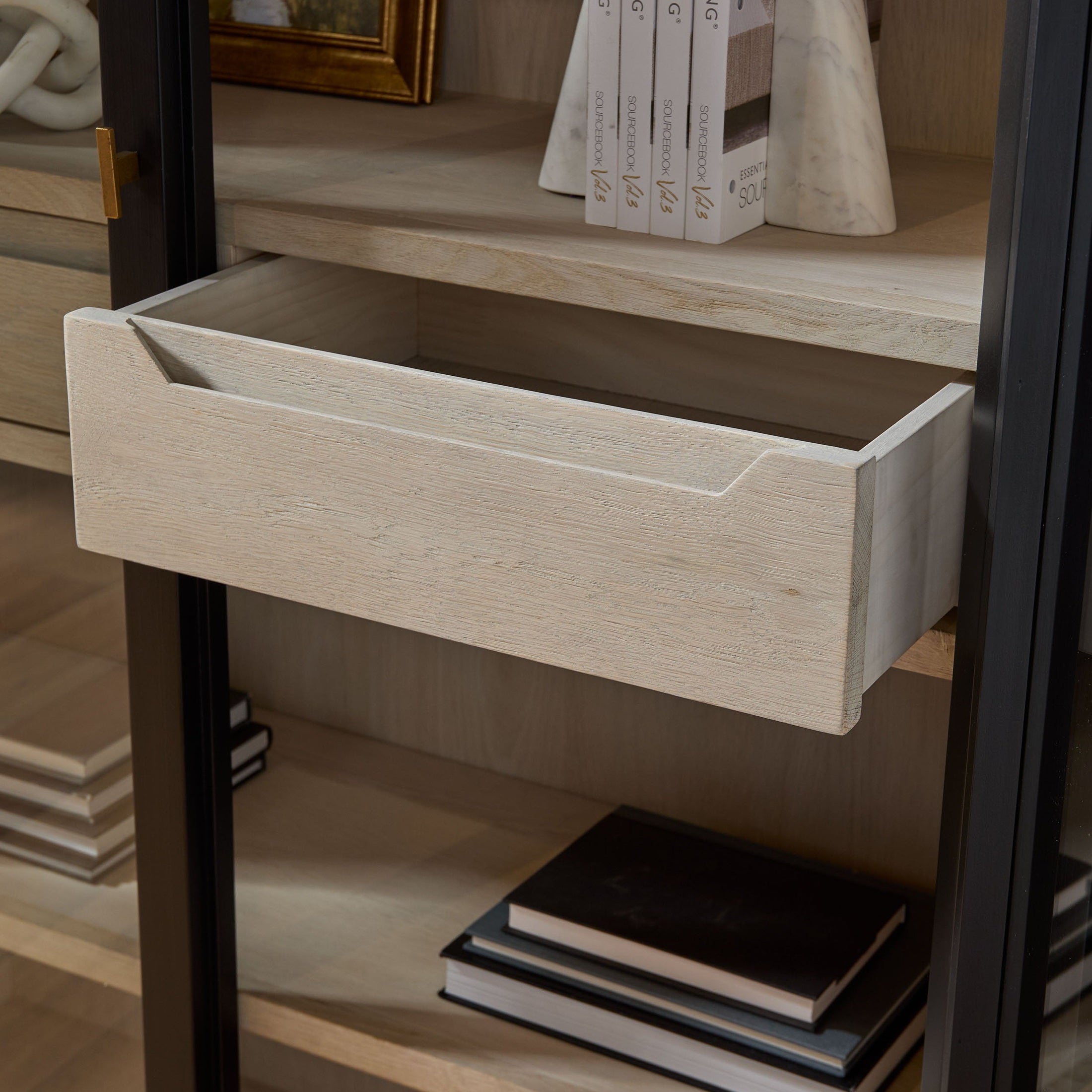 Open natural oak drawer inside Toulouse Display Cabinet by Essentials For Living with black birch frame and glass doors