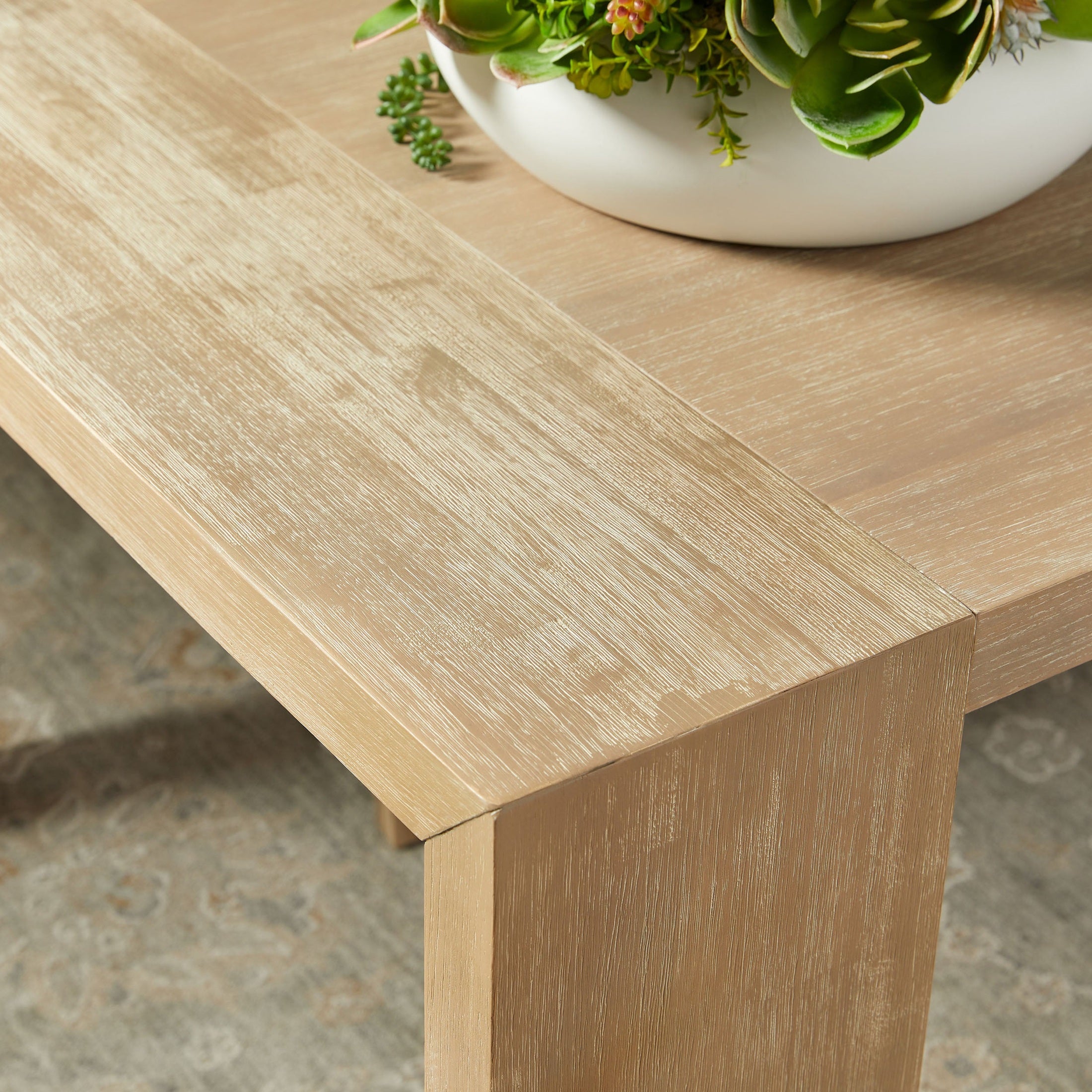 Close-up of natural gray acacia wood corner on Tropea Extension Dining Table with wire-brushed texture and modern design
