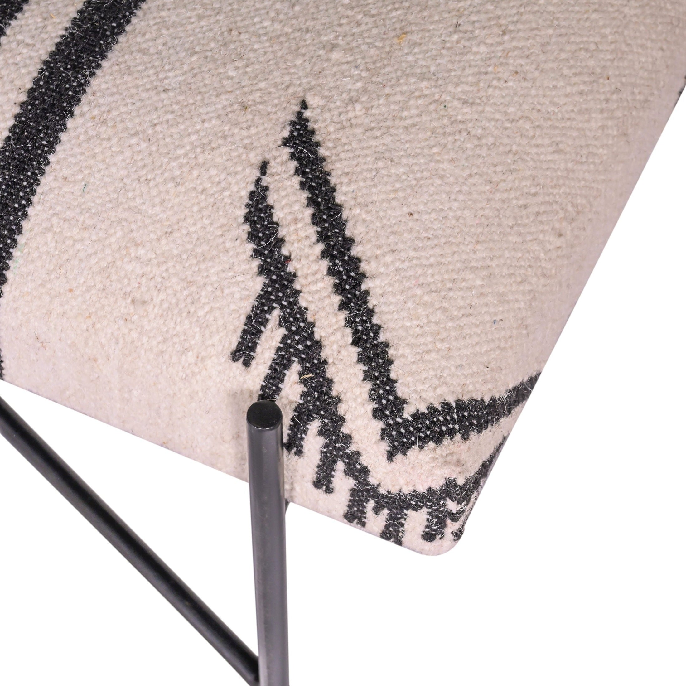 Close-up of Southwestern-style woven black and white seat on WULLEN BENCH with black iron legs by GO HOME