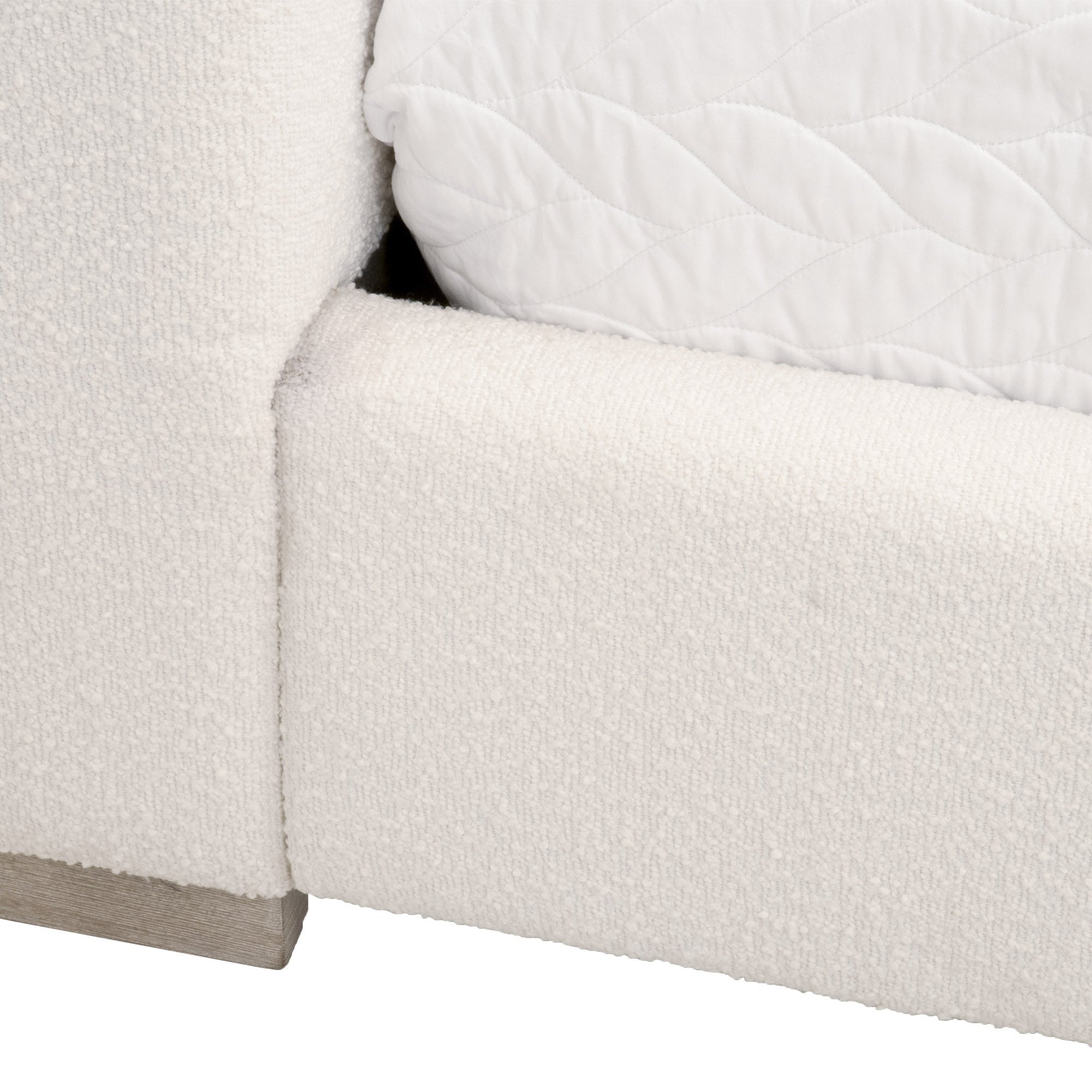 Close-up of Warren Queen Bed upholstered in snow white LiveSmart Boucle fabric with natural gray solid oak leg detail