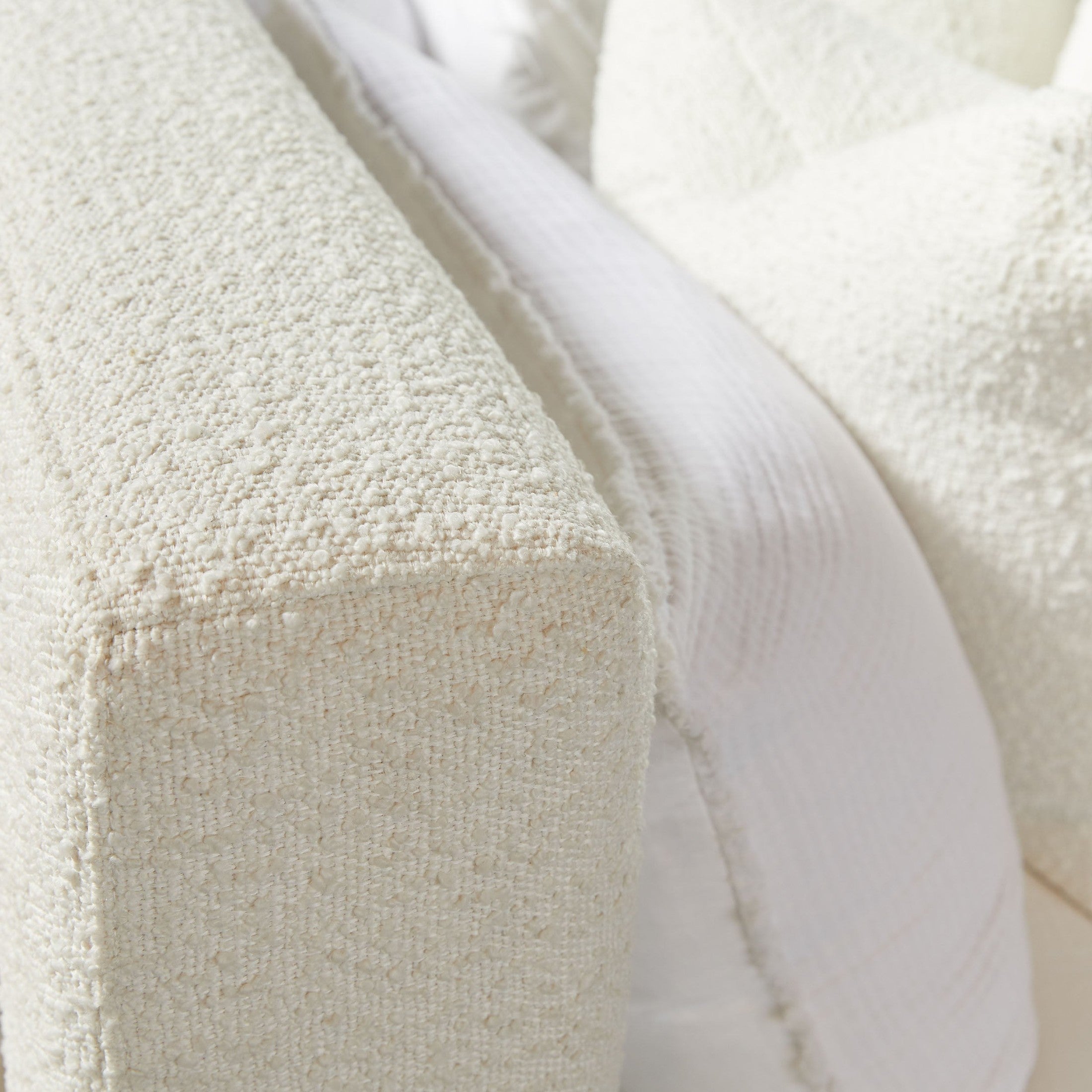 Close-up of Warren Queen Bed upholstered in textured snow white LiveSmart Boucle fabric by Essentials For Living