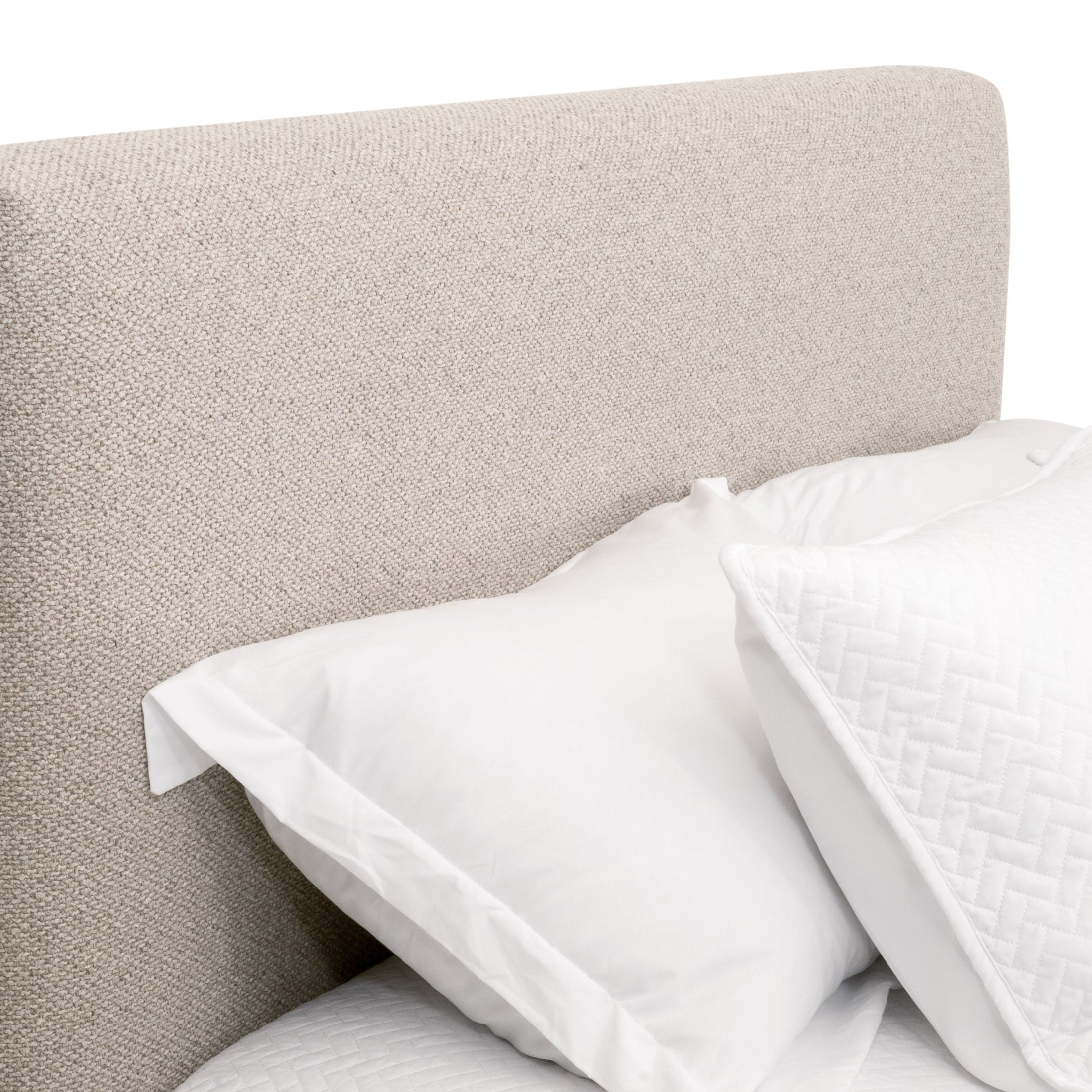 Close-up of the Warren Standard King Bed’s textured Snow white Boucle upholstery and pillows by Essentials For Living