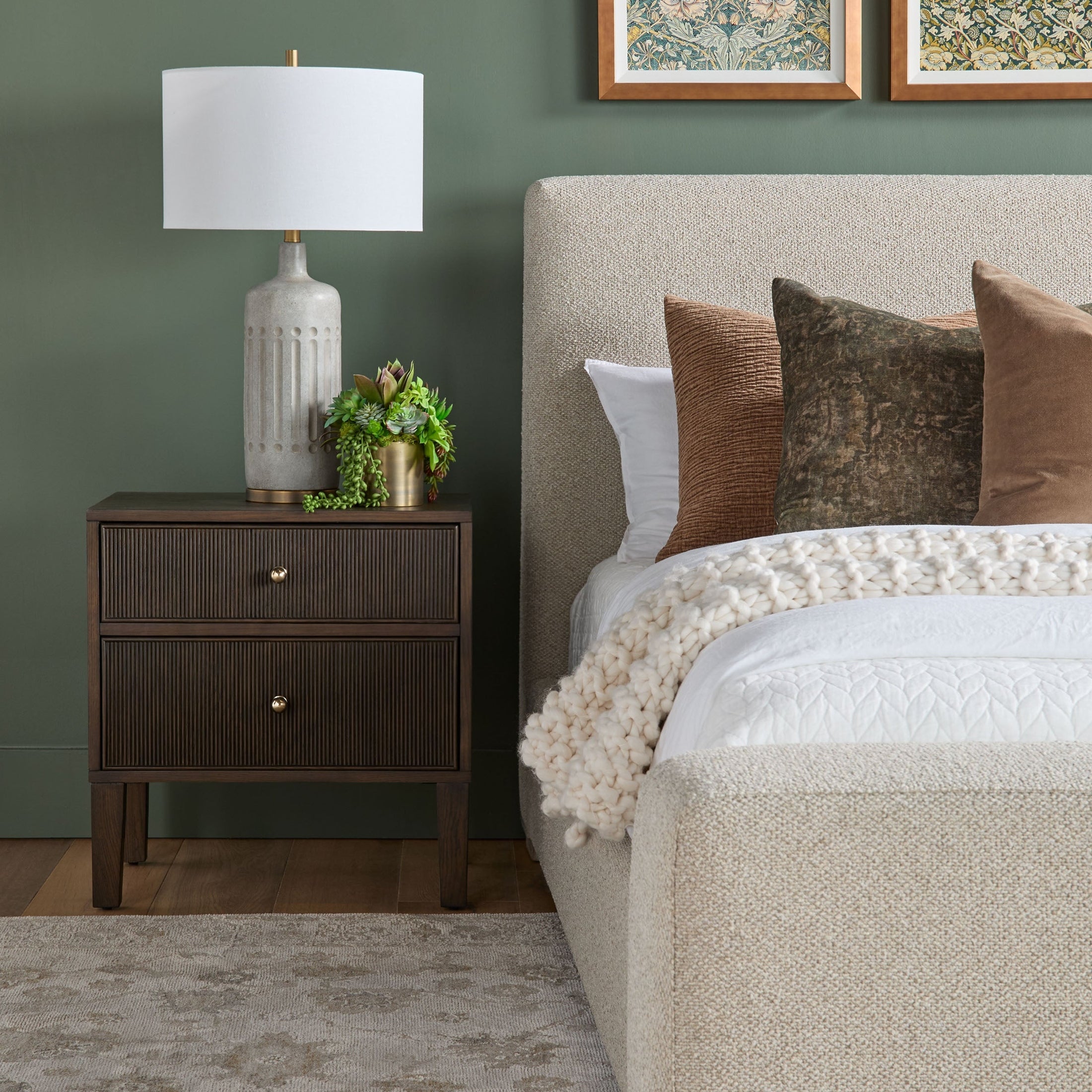 Side view of Warren Queen Bed by Essentials For Living with textured white upholstery and decorative pillows in a bedroom setting