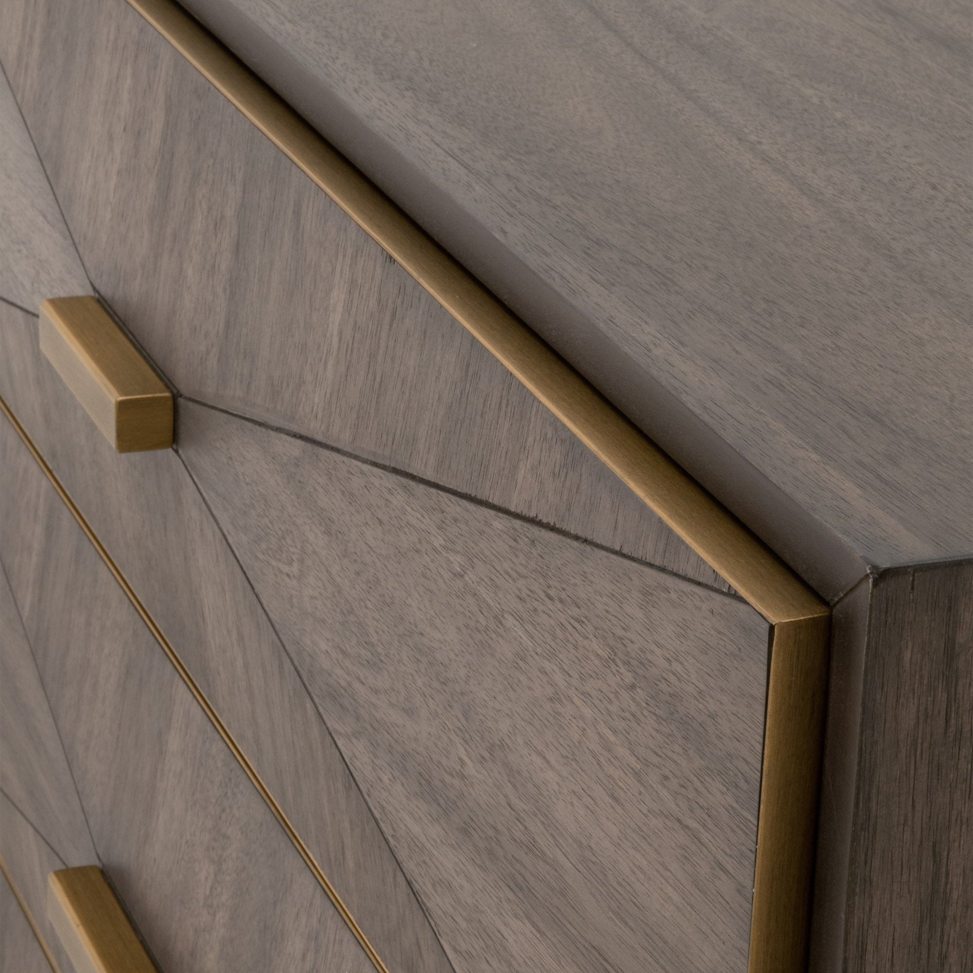 Close-up of Wynn nightstand drawer front with burnished brown acacia veneer and brushed gold frame and handles