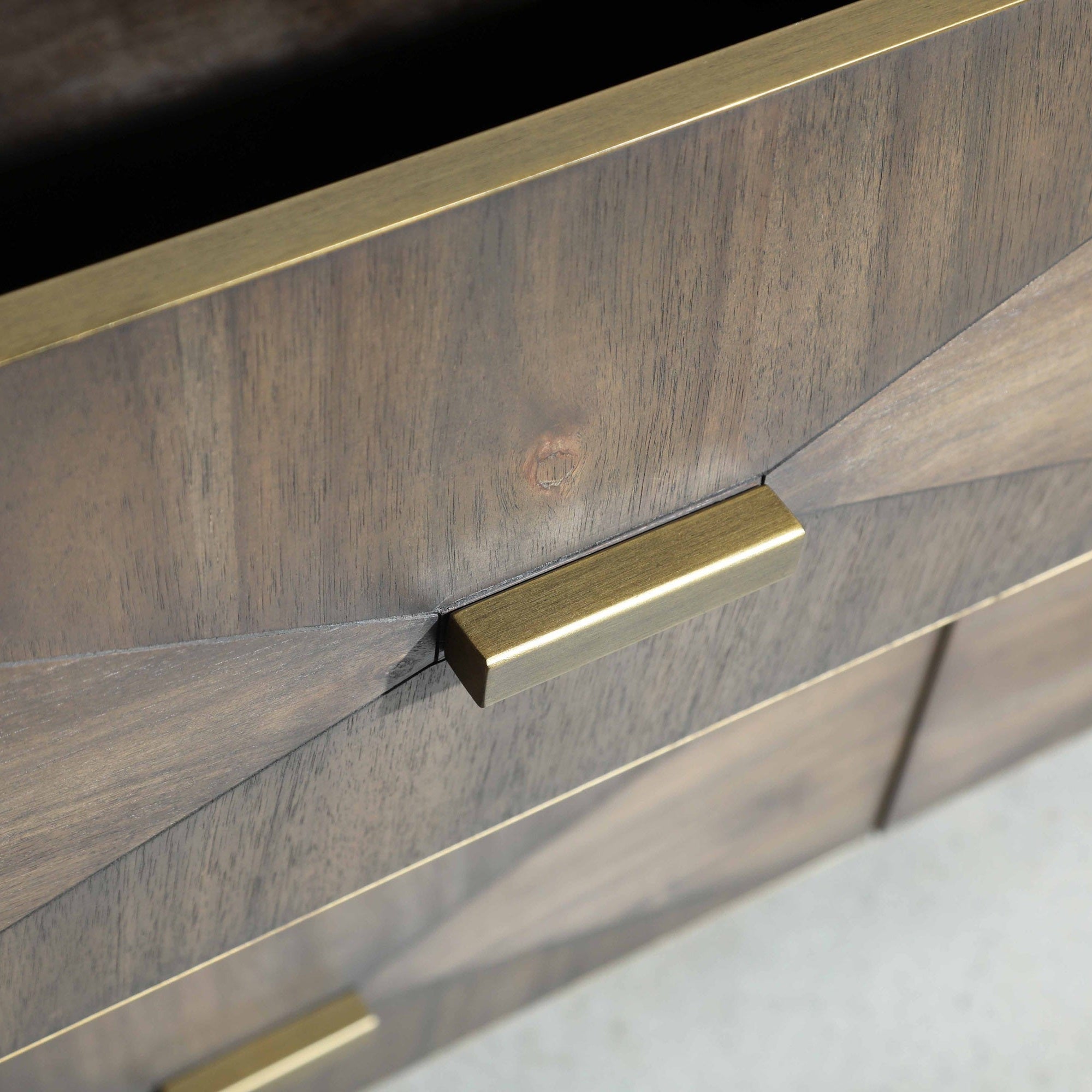Close-up of Wynn double dresser drawer front in burnished brown acacia veneer with brushed gold handle and textured design